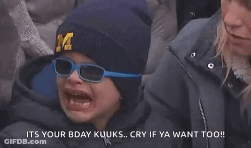 Young Boy In Hat With Letter M Crying While Woman Looks On GIF