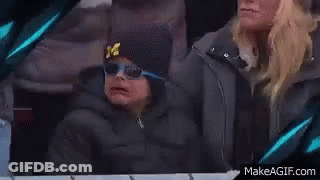 Young Boy In Hat With M Sitting Next To Woman GIF
