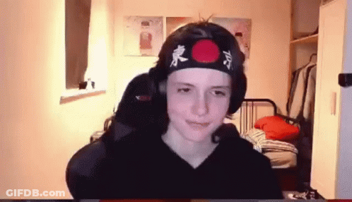 Young Boy In Headband With Red Circle Sitting At Computer GIF