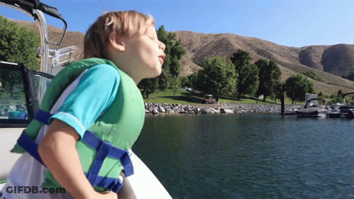 Young Boy In Life Jacket On Boat GIF