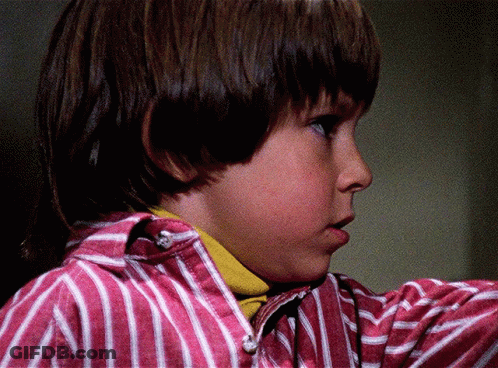 Young Boy In Pink And White Striped Shirt Looking Aside GIF