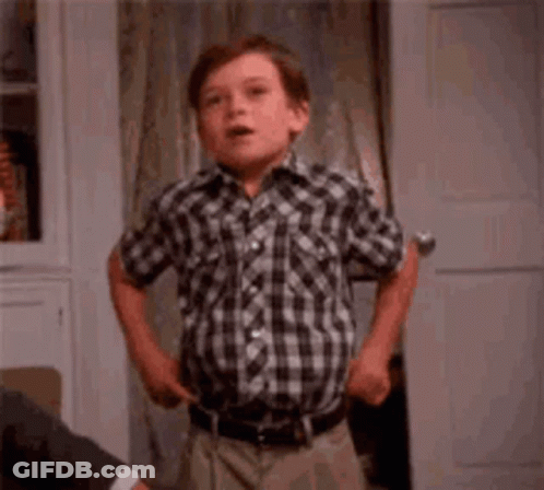 Young Boy In Plaid Shirt Making Funny Face At Door GIF