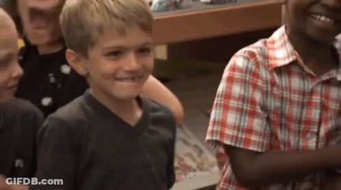 Young Boy In Plaid Shirt Smiling GIF