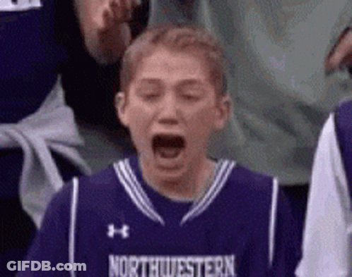 Young Boy In Purple Northwestern Jersey Yawning GIF