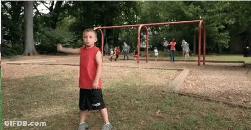 Young Boy In Red Shirt And Black Shorts In Park GIF