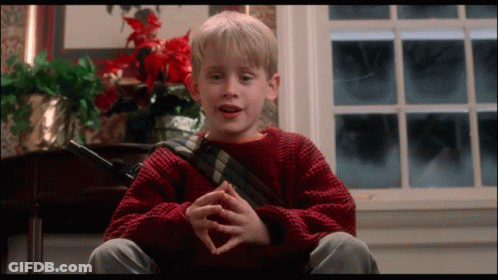 Young Boy In Red Sweater Sitting At Window GIF