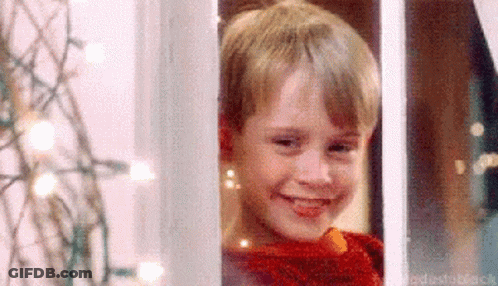 Young Boy In Red Sweater Smiling Out Window GIF