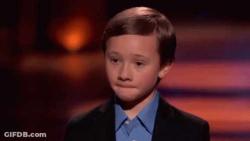 Young Boy In Suit And Blue Shirt On Stage GIF