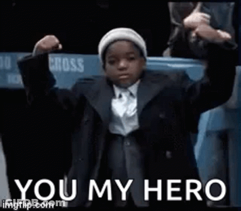 Young Boy In Suit And Tie With Hands In Air GIF