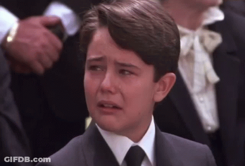 Young Boy In Suit Crying In Crowd GIF