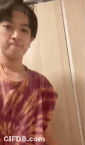 Young Boy In Tie Dye Shirt And Headband GIF