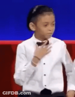 Young Boy In Tuxedo And Bow Tie Blue Background GIF
