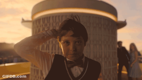 Young Boy In Tuxedo And Bow Tie In Front Of Building GIF
