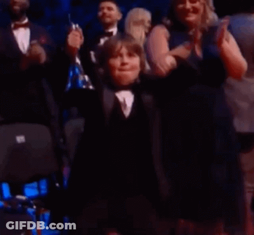 Young Boy In Tuxedo Applauded By Crowd GIF