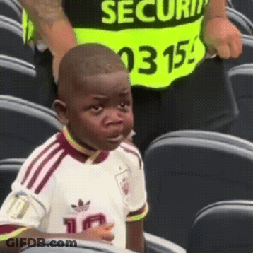 Young Boy In White Adidas Shirt Sitting In Stadium GIF