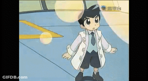 Young Boy In White Coat And Tie Standing In Room GIF
