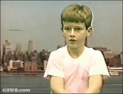 Young Boy In White Shirt With City Skyline GIF