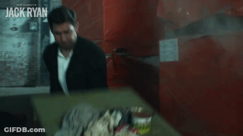 Young Boy In White Sweater Crawling Under Red Curtain GIF