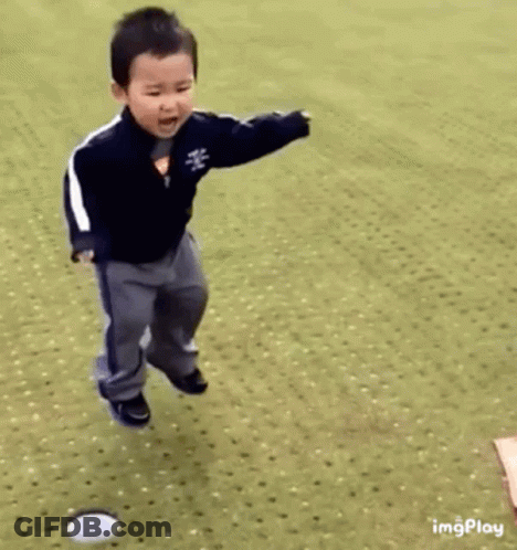 Young Boy Jumping And Playing With Ball GIF