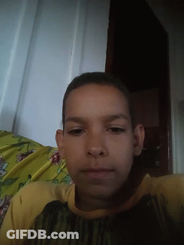 Young Boy Laying On Bed With Yellow Blanket GIF