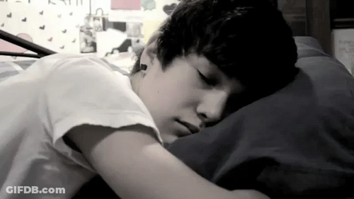Young Boy Lying In Bed Eyes Closed GIF