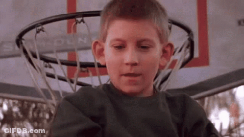 Young Boy Making Funny Face At Basketball Hoop GIF
