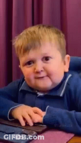 Young Boy Making Funny Face At Computer GIF
