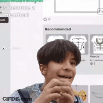 Young Boy Making Funny Face Holding Hands In Front Of Computer Screen GIF