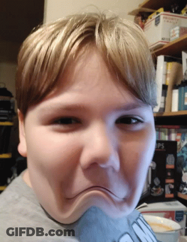 Young Boy Making Funny Face In Front Of Priority Mail Box GIF