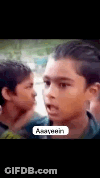 Young Boy Making Funny Face To Another In Crowd GIF