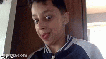 Young Boy Making Funny Face With Tongue Out GIF
