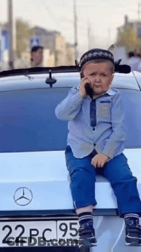 Young Boy On Car Back Talking On Phone GIF