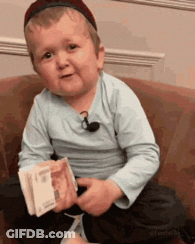 Young Boy On Couch Holding Money GIF