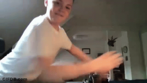 Young Boy Playing Video Game In White Shirt GIF