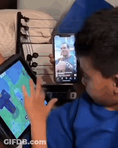 Young Boy Playing Video Game On Tablet And Cell Phone GIF