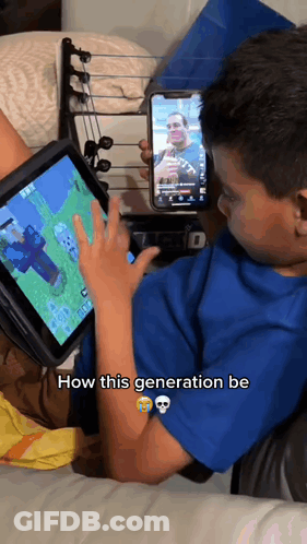 Young Boy Playing Video Game On Tablet Holding Phone GIF