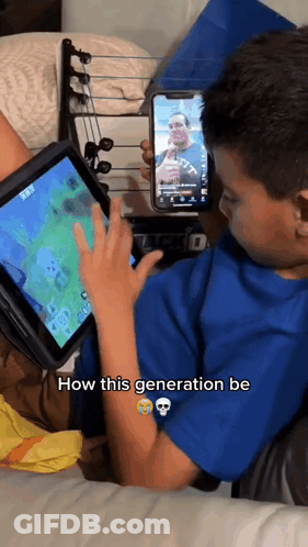 Young Boy Playing Video Game On Tablet While Holding Cell Phone How This Generation Be GIF