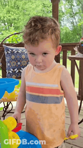Young Boy Playing With Toy Water Fountain On Porch GIF