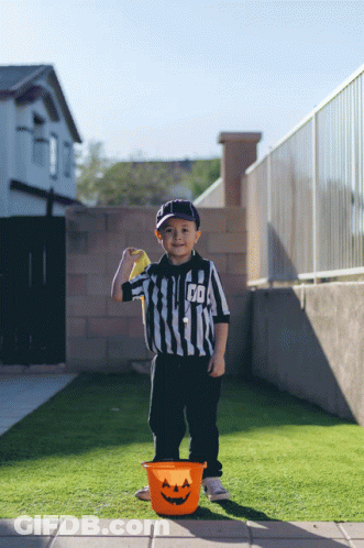 Young Boy Referee Holding Yellow Ball GIF