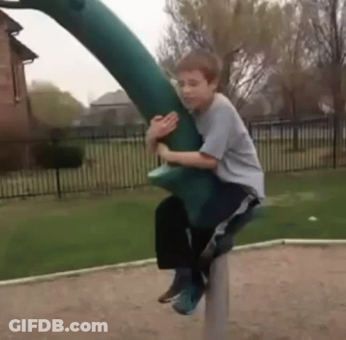 Young Boy Riding Green Dinosaur GIF