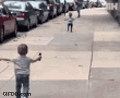 Young Boy Riding Scooter Arms Outstretched GIF