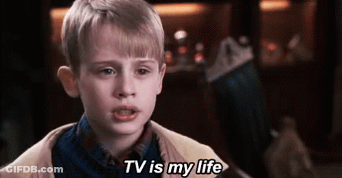 Young Boy Saying TV Is My Life In Front Of Christmas Stocking GIF