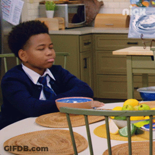 Young Boy Sitting At Table With Bowl Of Food And Nickelodeon Logo GIF