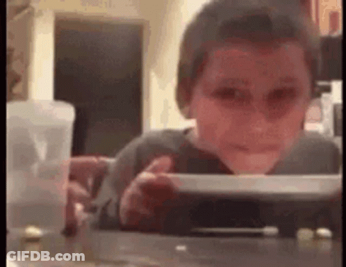Young Boy Sitting At Table With Food GIF