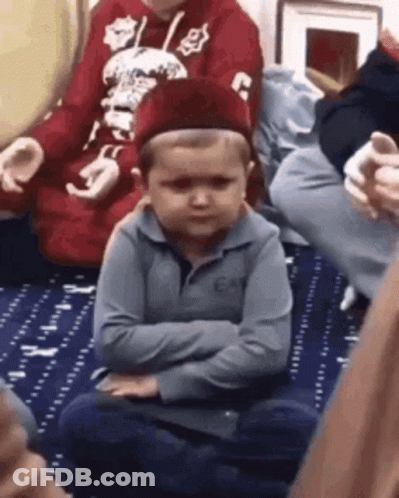 Young Boy Sitting Crossed Arms Wearing Hat GIF