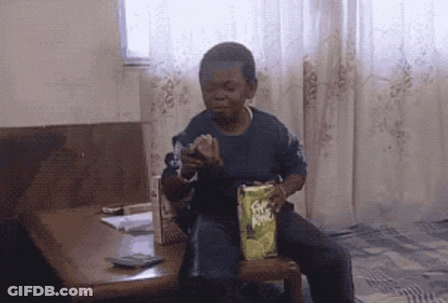 Young Boy Sitting In Chair Holding Fritos GIF
