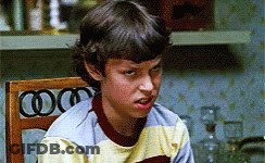 Young Boy Sitting In Chair With Mouth Open GIF