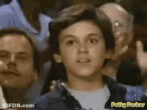 Young Boy Sitting In Crowd Patty Parker GIF