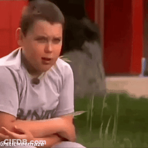 Young Boy Sitting In Grass Arms Crossed Sticker Maze Watermark GIF