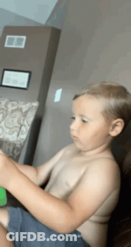 Young Boy Sitting On Couch GIF